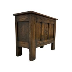 17th century design oak coffer or chest, rectangular hinged lid, the sides panelled with central front panel carved with a lozenge enclosing a flower head, raised on stile supports