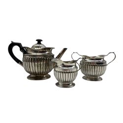 Victorian silver three piece tea set of circular design with reeded decoration, the teapot with ebonised handle and lift Birmingham  1882 Maker Hilliard & Thomason 23.5oz