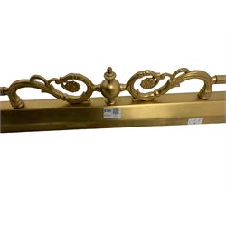 Mid-20th century brass fire fender with central scrolling design 