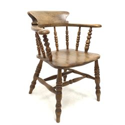 19th century elm and ash smokers bow armchair, shaped crest rail and swept arms over spindle supports, shaped saddle seat raised on turned supports and double 'H' stretcher W67cm