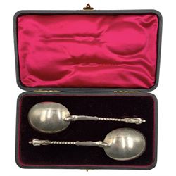 Pair of late Victorian silver serving spoons with gilded bowls, spiral twist stems and apostle finials, L19cm, cased, London 1899 Maker William Hutton & Sons Ltd 