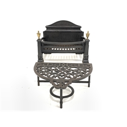 Cast iron fire grate with brass finials, (W50cm) and a 20th century demi lune cast iron footman (W39cm)