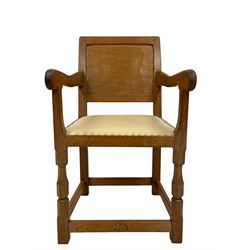 'Oakleafman' set five oak dining chairs, panelled backs, the seats upholstered in cream leather with stud band, octagonal front supports joined by stretchers, the front stretchers carved with leaf signature, four side chairs and one carver, by David Langstaff of Easingwold