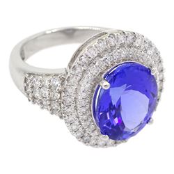 18ct white gold oval tanzanite and two row round brilliant cut diamond cluster ring, with diamond set shoulders, stamped 750, tanzanite approx 5.35 carat, total diamond weight approx 1.00 carat