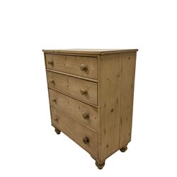 Victorian pine chest of drawers, the rectangular top over four long graduated drawers, raised on turned bun feet 