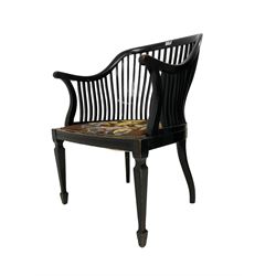 Early 20th century ebonised elbow chair, arched cresting rail with slat back, seat upholstered in foliate tapestry fabric with studwork, fluted frieze rail, raised on square tapering supports with spade feet