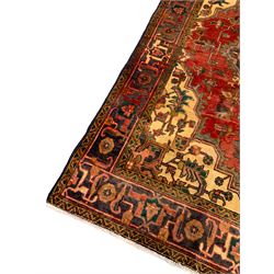 Persian Hamadan red ground rug, shaped central medallion with extending stylised plant motifs, the field decorated with stylised leaf and flower head motifs, paler spandrels with further foliate decoration, the main border with repeating stylised pattern within guard stripes