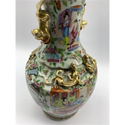 19th century Chinese Canton Famille Rose vase of baluster form, the exterior sides applied with gilt dragons and similar Dog of Fo handles, typically enamelled with court scenes, H33cm  
