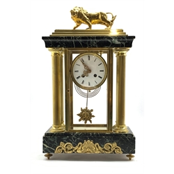 Late 19th century Empire design four glass, brass and marble mantel clock, surmounted by brass lion, over four reeded columns, stepped marble base embellished with gilt metal mounts depicting swans and scrolled foliate, raised on cast brass supports, the white enamel dial with Roman numeral chapter ring over sunburst pendulum, eight day twin spring driven movement, stamped 'H & C PARIS', W28cm