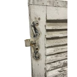 Pair of 19th century French wooden shutters, in distressed white painted finish, with scrolled wrought iron hinges