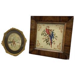 19th century woolwork picture depicting a parrot perched on a branch, within a square rosewood frame, 36.5cm x 36.5cm, together with a 19th century oval silk picture depicting a farmer in a landscape, within an oval gilt frame (2)
