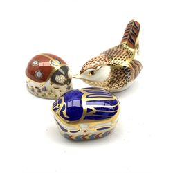 Royal Crown Derby 'Millenium Bug' paperweight with certificate, another modelled as a seven spot Ladybird and another of a Wren, collectors guild exclusive, all boxed and with gold stoppers