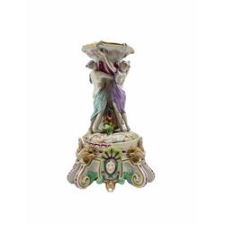 Late 19th century Meissen porcelain centrepiece stand, the stem decorated with three maidens in classical robes, on large scroll base applied with Rams masks and female heads, H34cm overall 