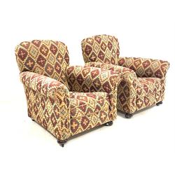 Early 20th century two seat sofa, upholstered in kilim type fabric raised on turned front supports with recessed castors (W142cm, H83cm, D93cm) together with a pair of matching armchairs, (W90cm)
