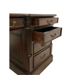 Georgian design mahogany twin pedestal partner's desk, shaped and moulded top with three leather inset writing surfaces, each side fitted with six drawers and panelled cupboard, canted upright corners with reeded quarter columns, on plinth base