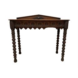 Late 19th century carved oak console or side table, raised arched back, the frieze carved with repeating rosettes, raised on bobbin turned supports