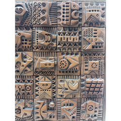 Ron Hitchins (British 1926-2019): A framed wall plaque depicting twenty-eight terracotta square panels, having relief and impressed decoration, inset in a wooden frame, signed verso 37cm x 22cm, together with a vintage square section lamp base inscribed 'John' H44cm 