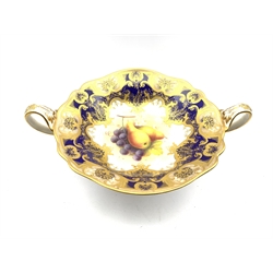 Royal Worcester porcelain twin-handled comport painted by Albert Shuck, signed, with grapes and pears, the border with six shaped cartouches in pink applied in gilt with leafy scrolls jewelled in gilt, on a cobalt blue ground, L33cm x H14.5cm 