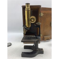Baker of London three drawer brass and leather telescope, the first drawer inscribed 'Baker, 244 High Holborn, London', L77cm extended, together with a 
telescope together with an early 20th century Bausch Lomb black lacquer and brass microscope, in fitted case (2)