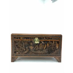 Chinese camphor wood chest, the hinged lid with plate glass top revealing interior fitted with sliding tray, brass locking plate, profusely carved in relief with oriental scenes, W100cm, H58cm D50cm