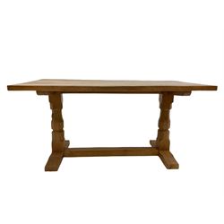 'Mouseman' oak dining table, rectangular adzed top, twin octagonal pillar supports on sledge feet joined by floor stretcher, carved with mouse signature, by Robert Thompson of Kilburn W86cm, H74cm, D152cm 