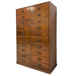 Late 19th century mahogany straight-front chest, fitted with two vertical banks of ten drawers, each fitted with Aesthetic Movement brass handles with foliate decoration, each drawer flanked by reeded decoration, raised on a plinth base