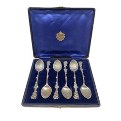 Set of six cased Sterling silver York Minster teaspoons with floral stems , import marks for London 1904 and retailed by Inglis, York