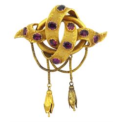 Victorian 15ct gold garnet knot brooch, foliate engraved and set with oval cut garnets, suspending gold pendant drops from swag chains
