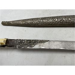 19th century Turkish Yataghan sword, the slightly curved 60cm blade with engraved decoration and with floral panels, two piece walrus ivory grip in a silvered metal scabbard with floral and geometric decoration