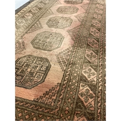 Persian design Bokhara runner rug, with gul motif on red field enclosed by multi line border, (81cm x 294cm) together with another similar rug, (70cm x 252cm)