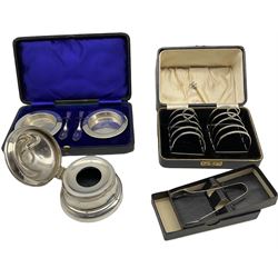 Silver capstan inkwell with hinged lid D9cm Birmingham 1910 Maker A & J Zimmerman, pair of silver four division toast racks, Birmingham 1932/3, cased, pair of silver butter dishes and knives, cased and a pair of silver sugar tongs, weighable silver 5.5oz