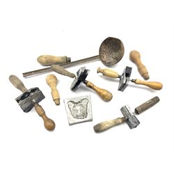 A group of lead modelling moulds, together with a pouring ladle 