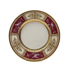 Mid 20th century Minton plate decorated with three pâte-sur-pâte panels of birds on a cerise ground within raised gilt borders, signed L. Wood and numbered H5103, retailed by T. Goode & Co. Ltd, D20cm, together with another Minton plate with heavily gilded border (2)