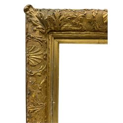 19th century heavy gilt stepped exhibition frame, decorated with foliate and cartouche motifs with scrollwork, aperture 33cm x 25cm