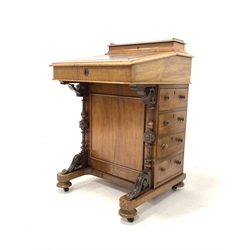 Victorian Mahogany davenport, cartouche shaped raised back with hinged lid enclosing storage well, skivered writing surface to sloped front lifting to reveal more storage space, four drawers opposite four faux drawers, spiral turned and block pilasters over scrolled acanthus leaf, raised on compressed bun supports and wooden castors, W52cm