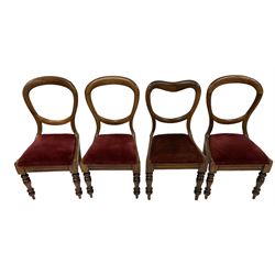 Set four Victorian mahogany framed dining chairs, balloon back with crimson drop-in seat, carved frieze rail, raised on turned supports