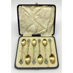 Set of six silver gilt coffee spoons, the finials decorated with a coloured enamel flower head, the stems with green panels and white dots Birmingham 1934 Maker Turner & Simpson