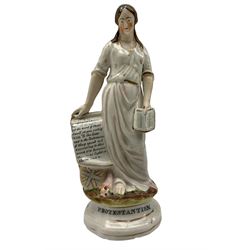 19th century Staffordshire figure depicting 'Protestantism' modelled as a woman holding a bible, with scroll of religious text, above union jack, mounted on pediment H23cm