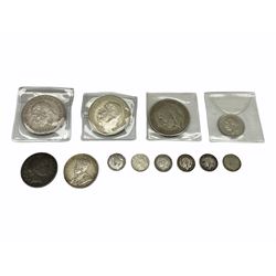 Three King George V 1935 Great British crowns, 1936 one shilling coin, various threepence pieces, Canada 1917 fifty cents and a United States of America 1908 half dollar San Francisco mint