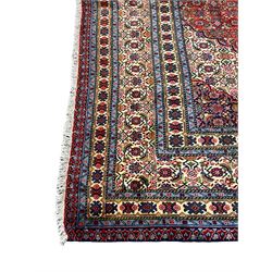 Persian Herati red ground rug, the cusped medallion and field borders decorated with repeating Herati motifs, multi-band border decorated with repeating stylised flower head motifs and geometric patterns