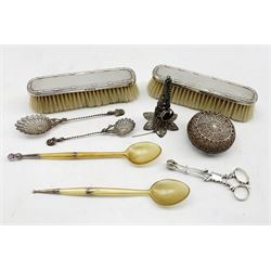 Two 19th century Scottish horn spoons with silver mounts, silver scissor action sugar nips, two silver backed brushes, filigree tussie mussie or posy holder and other filigree items