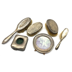 Silver circular table photograph frame Birmingham 1913, silver watch case and four various silver backed brushes 