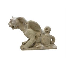 Composite stone grotesque or gargoyle statue, in a crouched pose on clawed feet with single horn and wings 