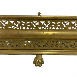 Victorian brass fire fender, D-shaped with pierced decoration, on paw feet