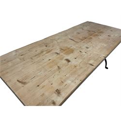 Stripped pine dining table, rectangular top raised on wrought metal curved X-frame base, united by spiral turned stretcher