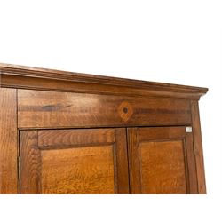 George III oak standing corner cupboard, stepped cavetto cornice over frieze with mahogany banding, top section fitted with two panelled cupboards enclosing a blue painted interior with four shelves and brass hooks, lower double cupboard enclosing two shelves, each with ivory escutcheons, raised on turned feet

This item has been registered for sale under Section 10 of the APHA Ivory Act