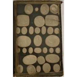 Collection of eighty six Grand Tour plaster intaglio seals of various shapes depicting classical figures, busts etc in two glazed cases one with an old paper label inscribed 'Opere de Luigi Pichler' (1773-1854) each case 33cm x 21cm