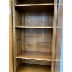  Large 20th century cherry French style library bookcase, three glazed doors with bevelled plates enclosing six adjustable shelves, three cupboards to base, W196cm, H226cm, D52cm  