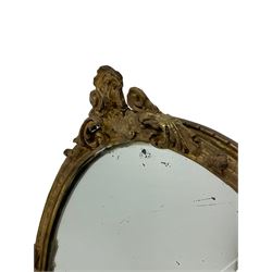 Near pair of 19th century giltwood and gesso framed oval wall mirrors, scrolled acanthus leaf and cartouche pediment over the moulded frame, mounted by scrolled foliage decoration 