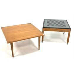 Mid to Late 20th century teak games table, the inset granite and slate top raised on square supports and castors (61cm x 61cm, H40cm) together with a mid 20th century teak lamp table (W71cm)